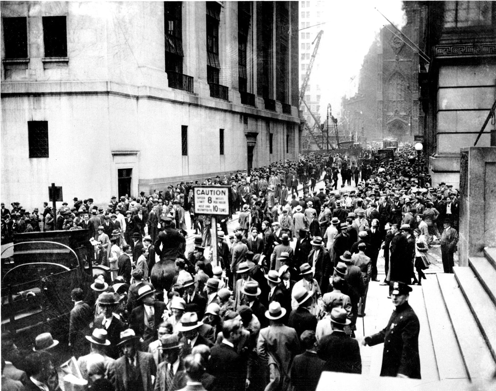 A dense crowd fills Wall Street outside the New York Stock Exchange in October 1929