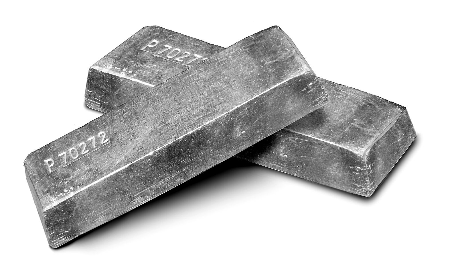 Three gold ingots stacked on a white surface