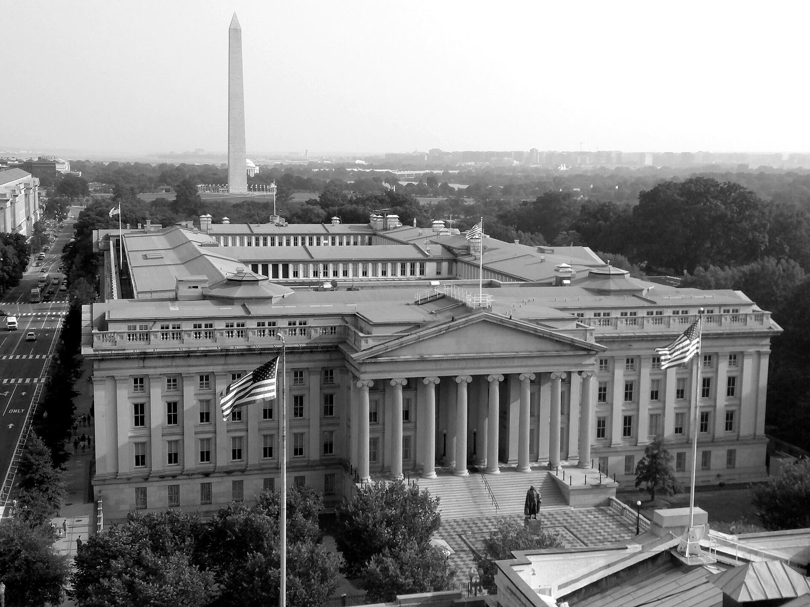 The U.S. Treasury building in Washington, with the Washington Monument behind it